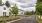 a road with trees and houses along it